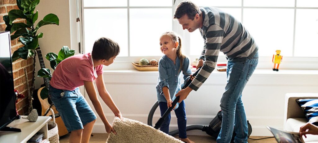 A family cleaning their home together, promoting a healthy living environment.