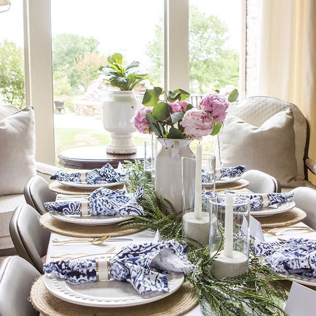 A dining table set for guests in a sparkling clean home.