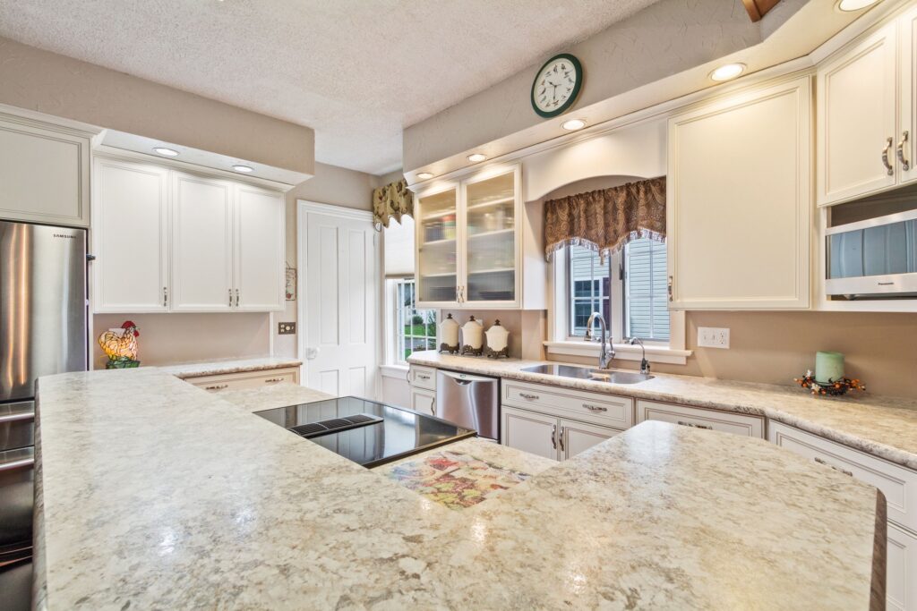 A clean and organized kitchen with spotless countertops and gleaming appliances.