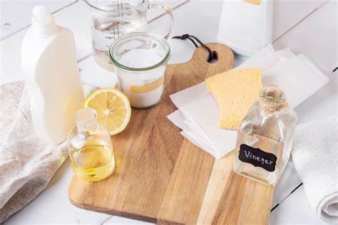 Essential cleaning tools for wood cutting boards, including mild soap, brush, lemon, vinegar, and mineral oil.