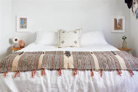 A freshly made bed with clean linens and fluffy pillows in a serene bedroom.