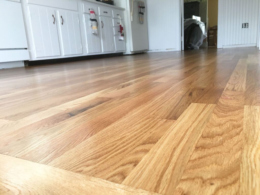 Close-up of polished hardwood floors reflecting light and showcasing cleanliness.