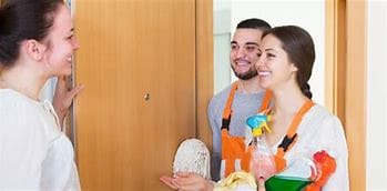 Cleaner and client sharing a smile while discussing cleaning preferences, highlighting rapport building