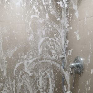 soap scum on shower glass before cleaning