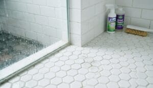 Close-up of moldy grout between bathroom tiles before cleaning